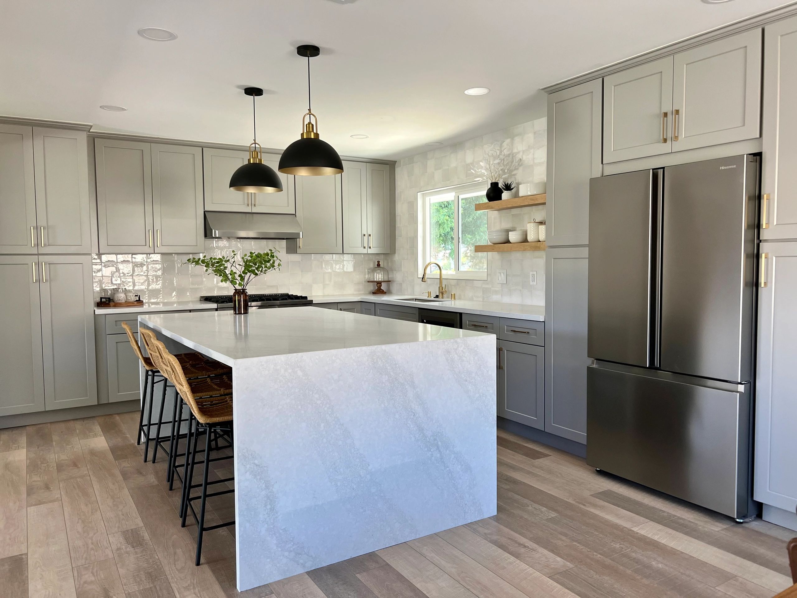 Modern kitchen with white shaker cabinets and quartz countertops.